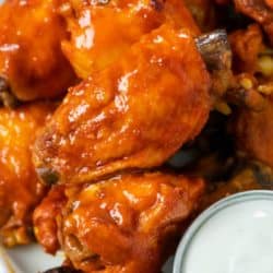 A labeled image of a plate of Crock Pot Chicken Wings with dipping sauce.