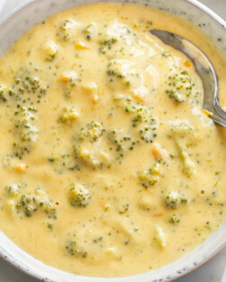 Broccoli Cheese Soup in a bowl with a spoon in it.