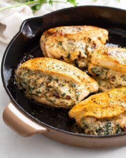 Stuffed Chicken Breast in a cast iron skillet.