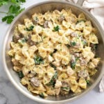 Mushroom Chicken Pasta in a skillet with a cream sauce and spinach.
